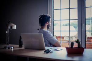 man looking out window